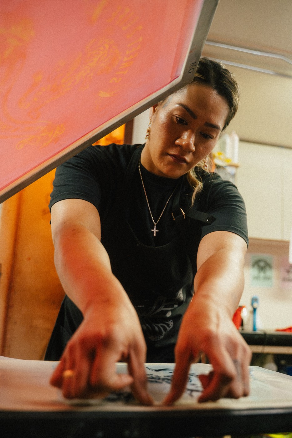 A crew member focused on lining up a print